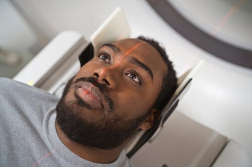 Male patient undergoing MRI scan in medical examination room